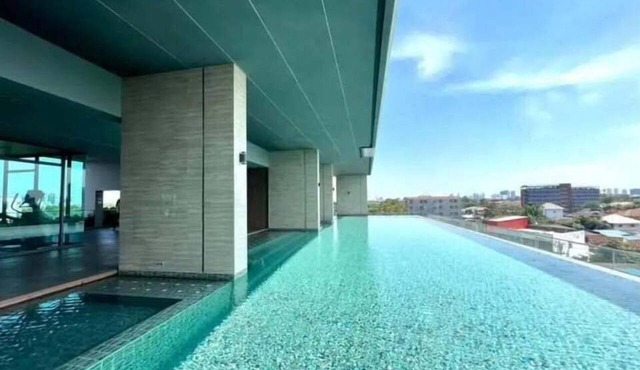 Modern 1-bedroom condo for up to 2 guests at Amber by Ester Star. Includes a separate bedroom, living area, kitchen, dining space, washing machine, balcony, city view and access to pool, gym, co-working space and shared building amenities. in Nonthaburi